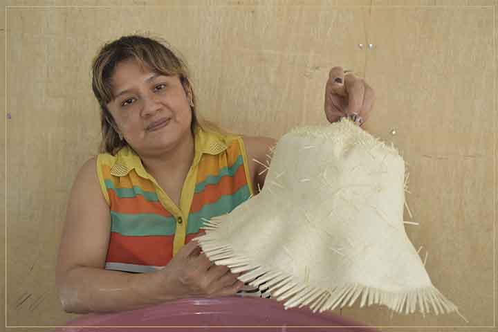 craftswoman washing toquilla straw hats